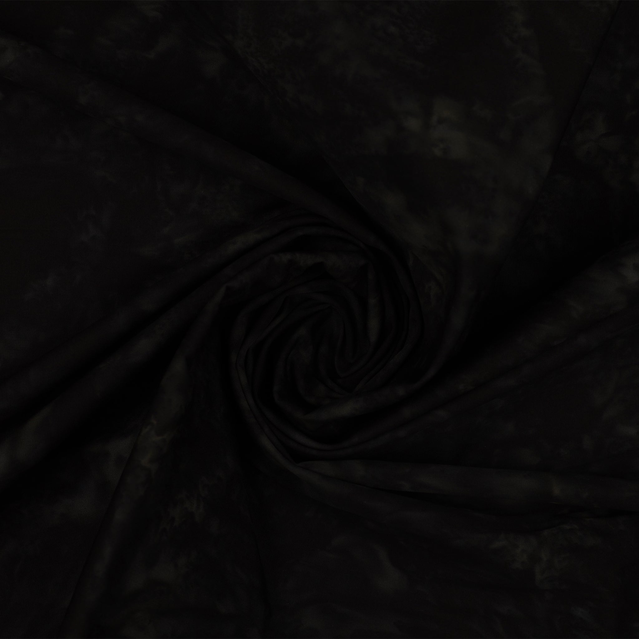 Black fabric with a subtle tonal pattern, styled in a central spiral swirl to show its drape and texture.