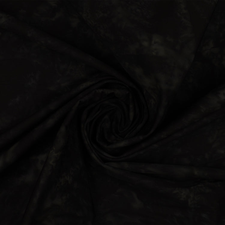 Black fabric with a subtle tonal pattern, styled in a central spiral swirl to show its drape and texture.