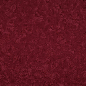 Sassy batik fabric with rich burgundy mottling and raspberry-red highlights.