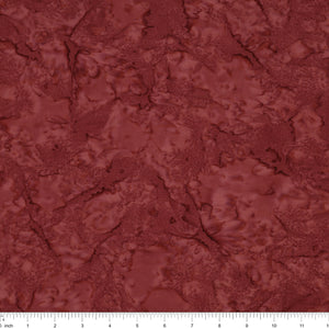 A close-up of a marbled fabric in a deep reddish-brown or burgundy shade, with a white ruler along the bottom edge showing scale.