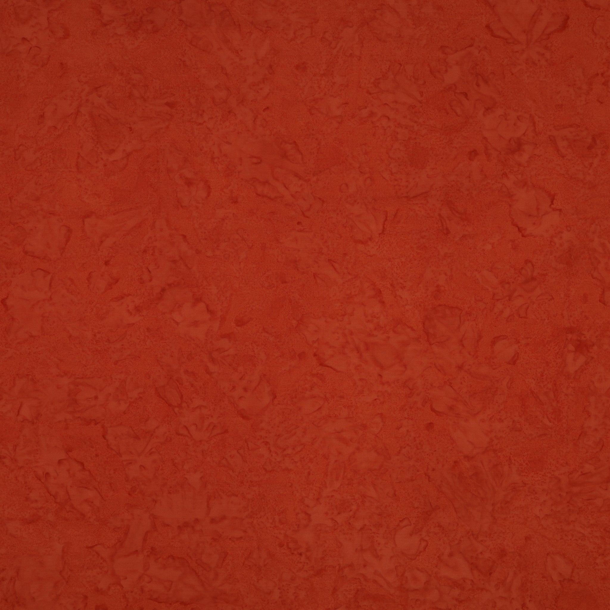 A close-up of a textured terracotta orange surface with subtle mottled variation.