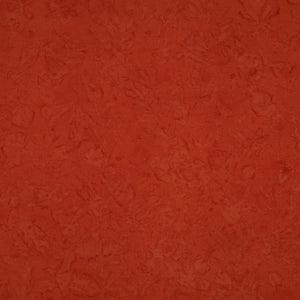 A close-up of a textured terracotta orange surface with subtle mottled variation.