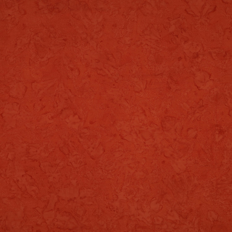A close-up of a textured terracotta orange surface with subtle mottled variation.