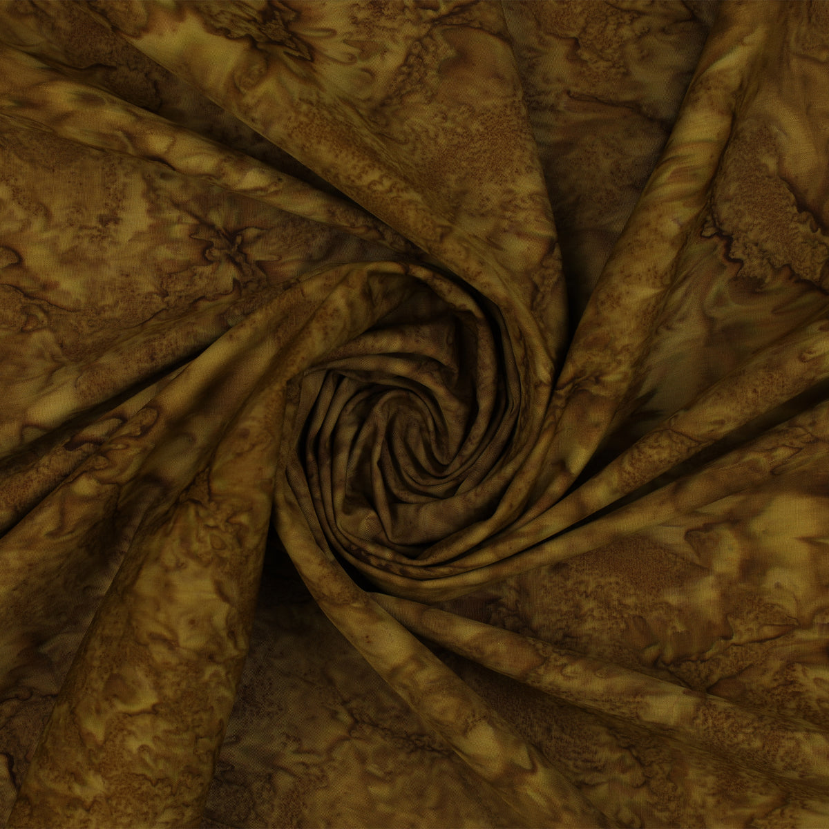Brown and tan batik fabric draped in a spiral swirl pattern, showing a mottled organic print.