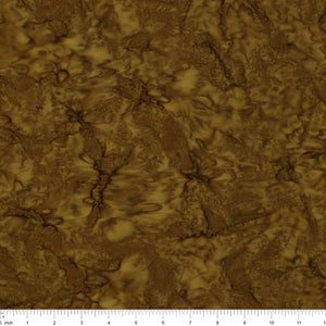A close-up of a brown and gold marbled fabric with a ruler scale along the bottom edge.