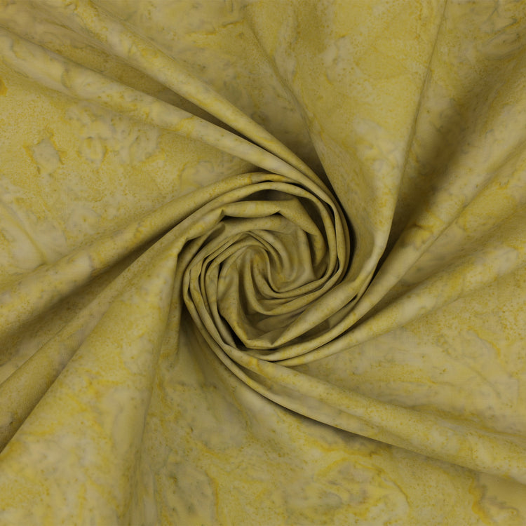 Yellow fabric with a marbled pattern, arranged in a spiral swirl to show its texture and drape.