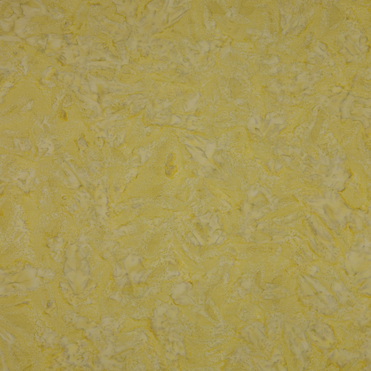 A close-up of a textured yellow fabric showing a mottled pattern.