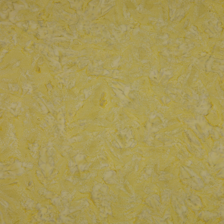 A close-up of a textured yellow fabric showing a mottled pattern.