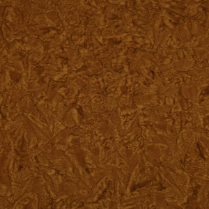 A close-up of a brown textured material with a mottled, organic surface pattern.