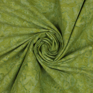 A close-up of olive green fabric with a marbled or mottled lighter yellow-green pattern, arranged in a spiral drape.