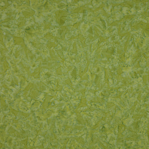 A close-up texture of a green fabric or wallpaper material with a mottled, organic pattern.