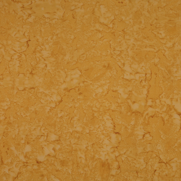 A close-up of a textured, mottled surface in warm golden yellow and orange-brown tones, filling the entire frame.