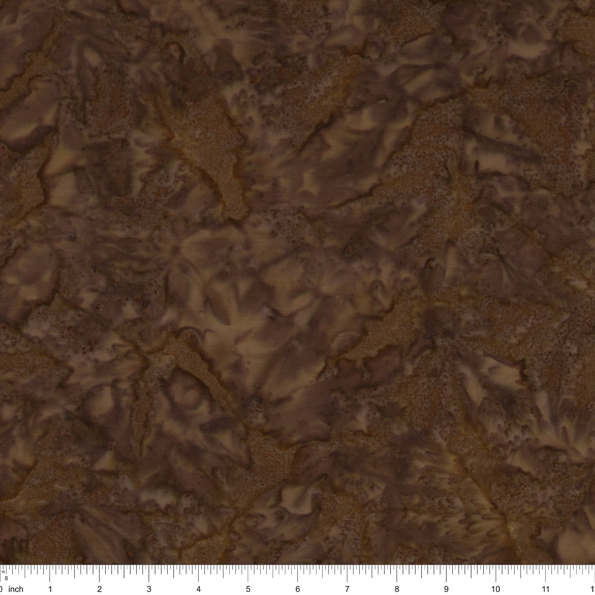 Brown batik fabric with a mottled, marbled pattern in shades of dark and light brown, featuring a 12-inch fabric ruler along the bottom edge.