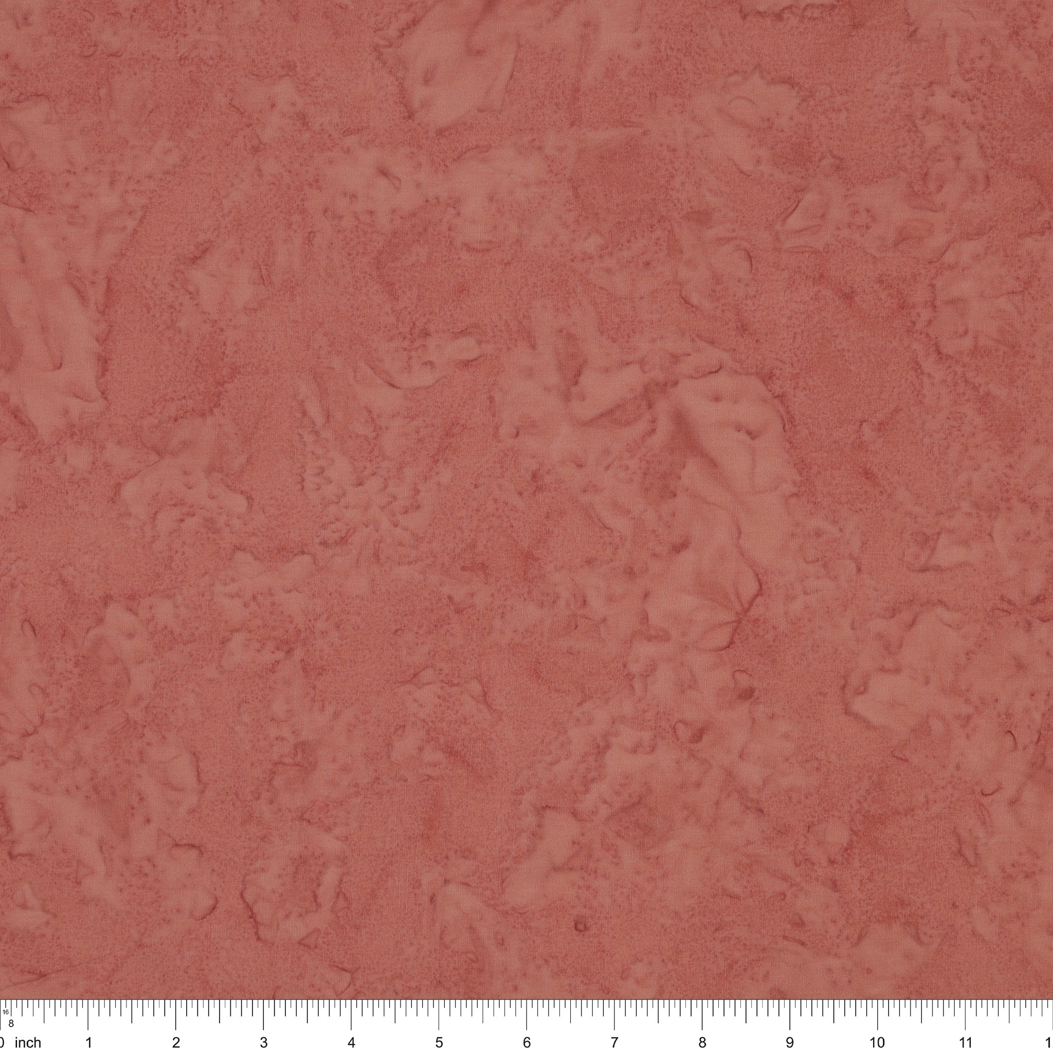 A close-up of a dusty rose surface with a white ruler along the bottom edge for scale.