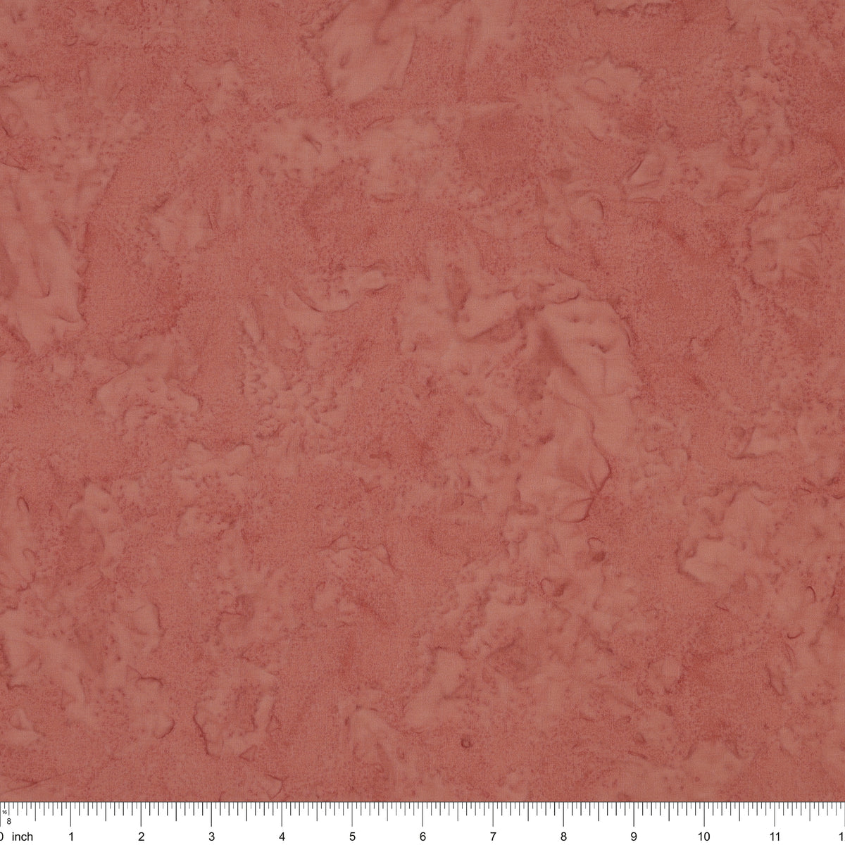 A close-up of a dusty rose surface with a white ruler along the bottom edge for scale.