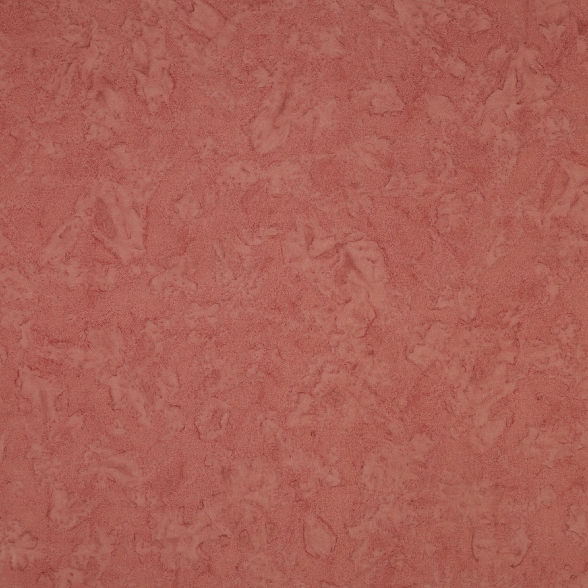 A close-up of a textured, mottled dusty rose pink surface, showing subtle variations in tone and a slightly distressed finish.