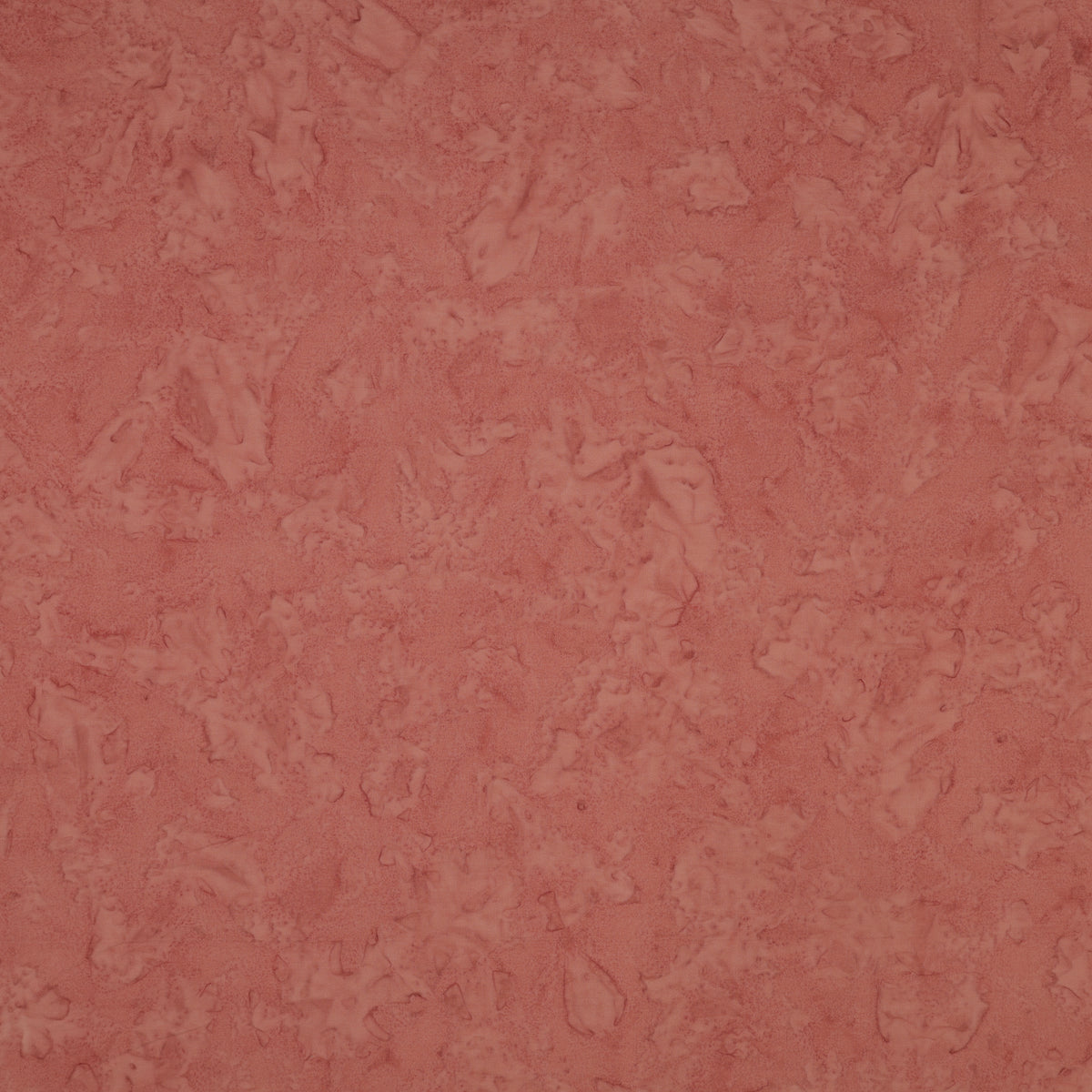 A close-up of a textured, mottled dusty rose pink surface, showing subtle variations in tone and a slightly distressed finish.
