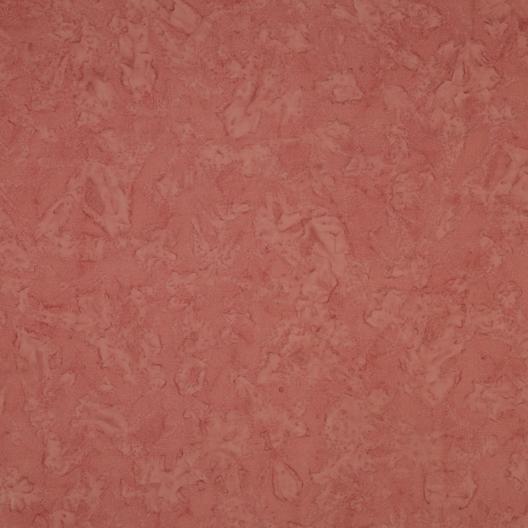 A close-up of a textured, mottled dusty rose pink surface, showing subtle variations in tone and a slightly distressed finish.