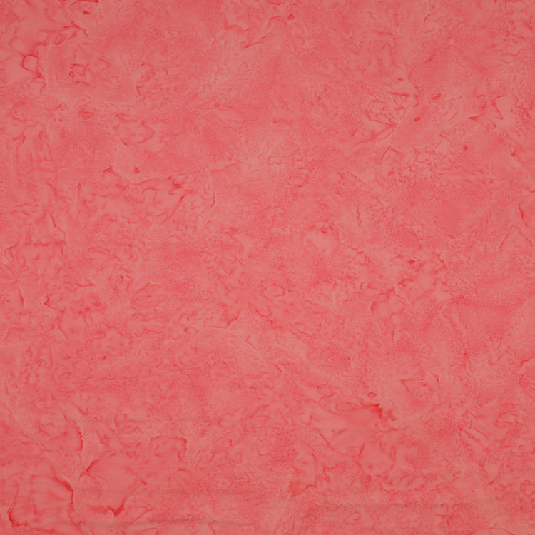 A close-up of a textured coral pink fabric filling the entire frame.