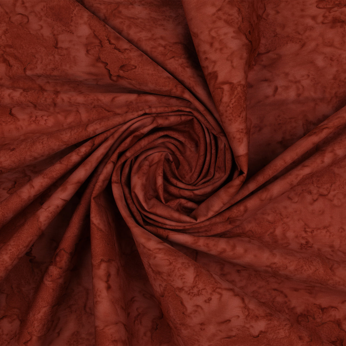 A close-up of draped fabric in a swirling spiral, showing a mottled reddish-brown pattern with darker shading.