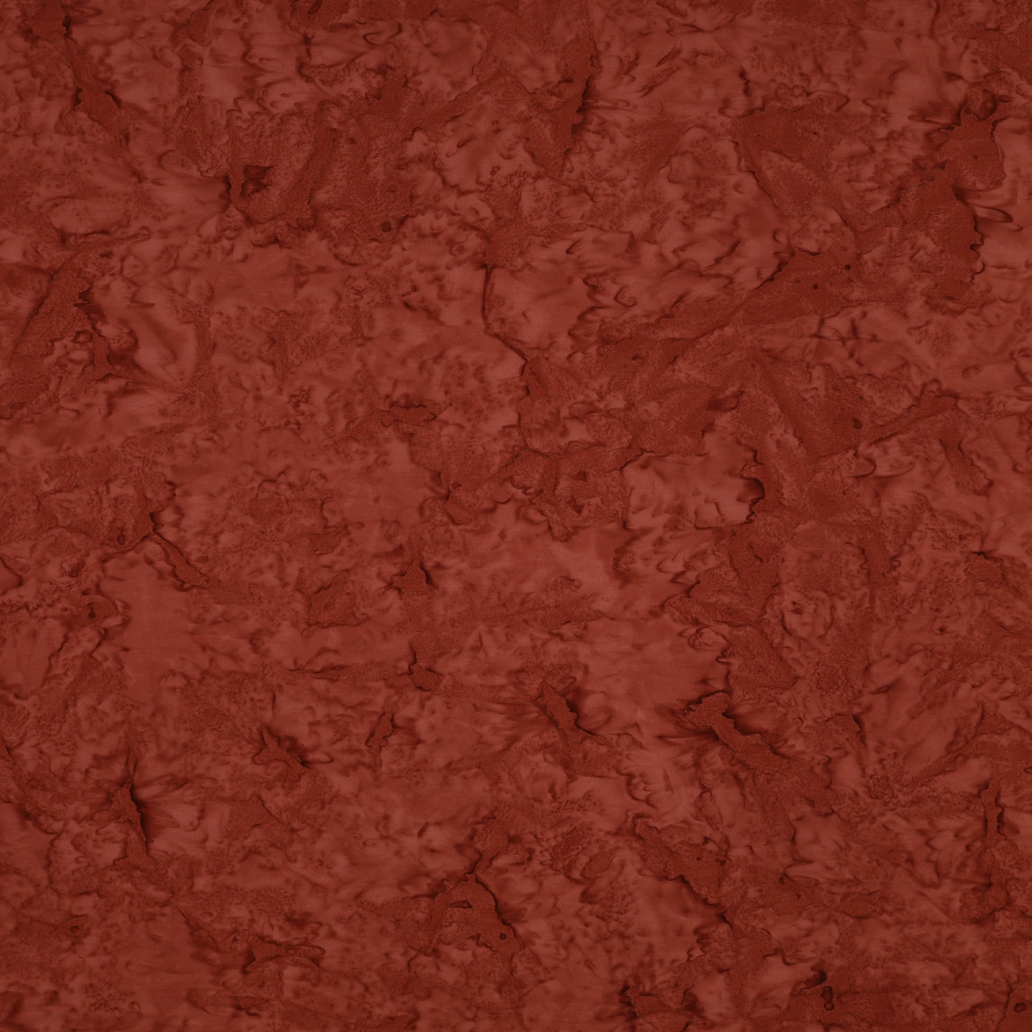 A close-up of a textured terracotta or rust-colored material with a mottled, organic surface pattern.