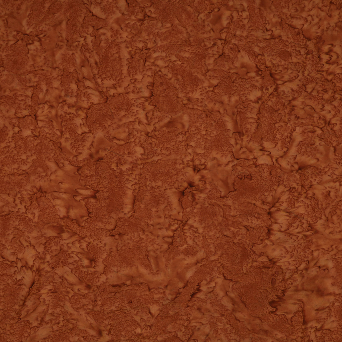 A close-up of a textured brown material with a mottled, organic surface pattern filling the frame.