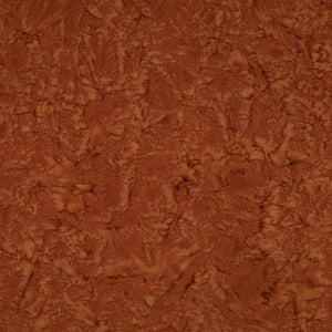 A close-up of a textured brown material with a mottled, organic surface pattern filling the frame.