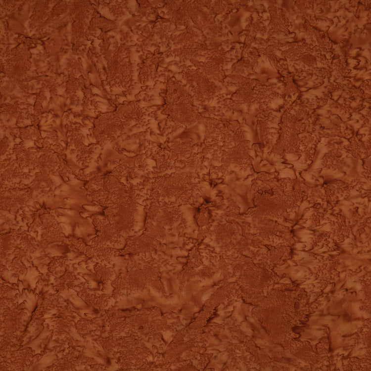 A close-up of a textured brown material with a mottled, organic surface pattern filling the frame.