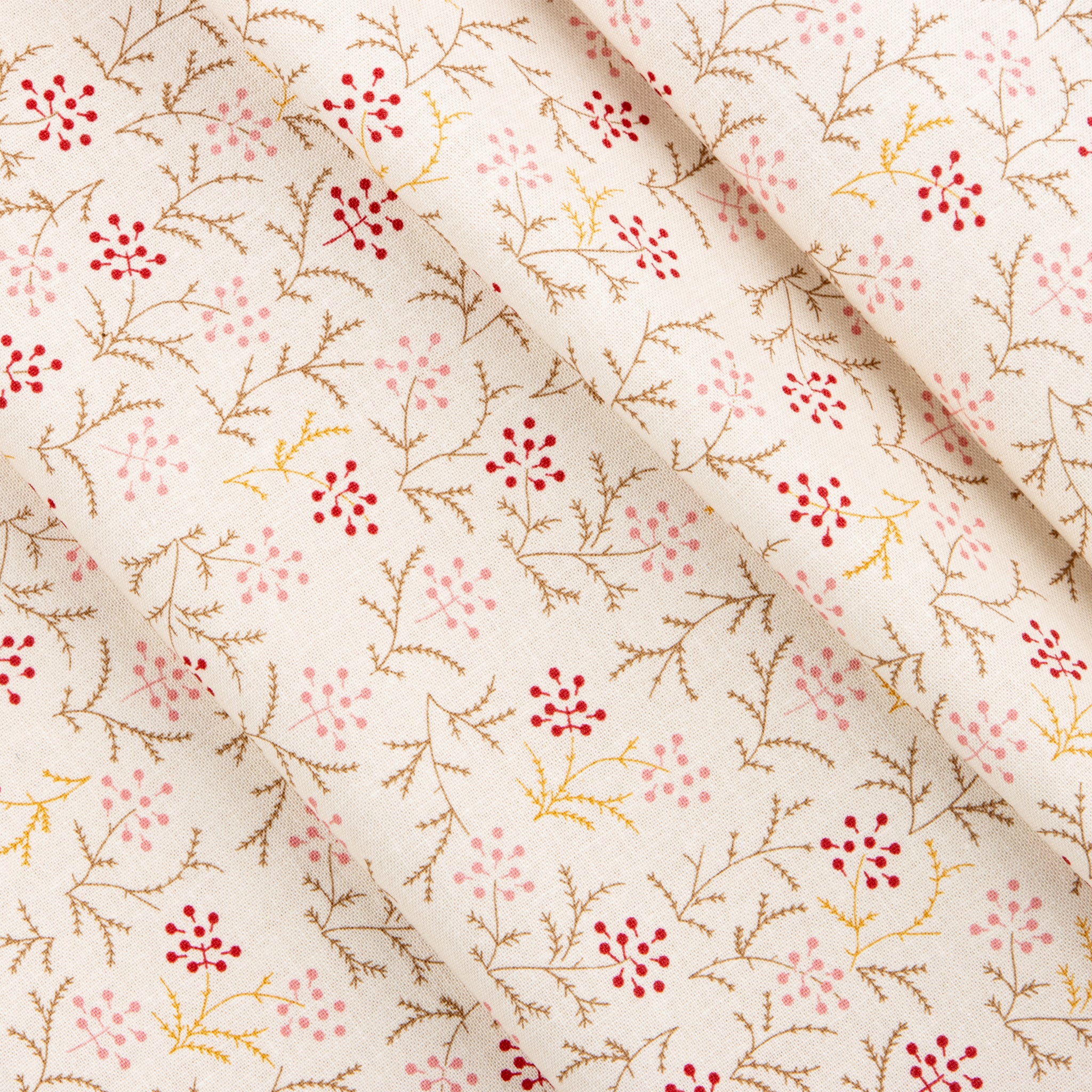 Cream fabric with delicate red and pink berry sprigs and fine brown branches.