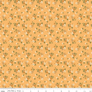 Floral pattern fabric on a peach background with a ruler along the bottom for scale. 