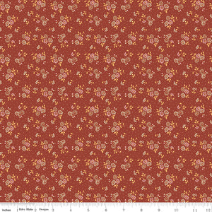 Floral pattern fabric swatch on a red background with a ruler along the bottom for scale. 