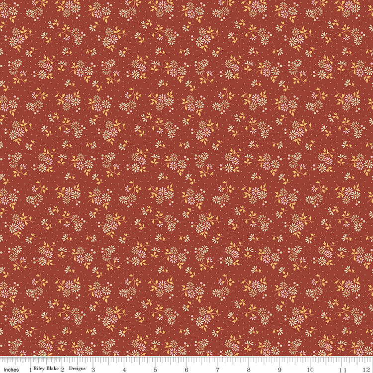 Floral pattern fabric swatch on a red background with a ruler along the bottom for scale. 