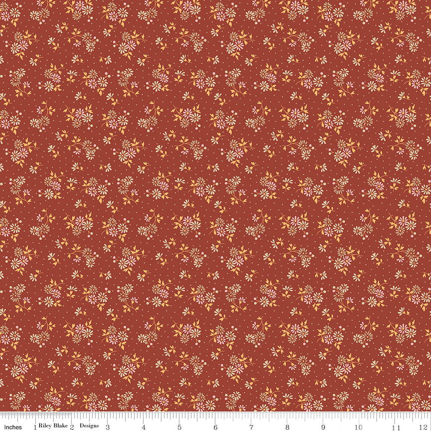Floral pattern fabric swatch on a red background with a ruler along the bottom for scale. 