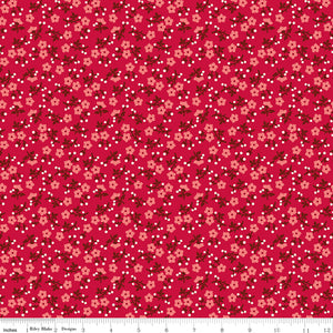 A repeating floral pattern on a bright pink background, featuring small peach flowers, dark red leaves, and scattered white dots. Ruler along the bottom for scale. 