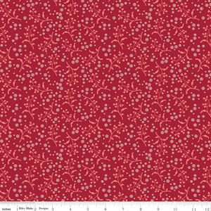 A repeating floral pattern featuring light pink vines and small white blossoms on a deep red background. Ruler along the bottom for scale. 