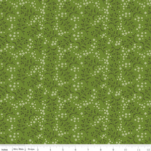 A repeating floral pattern featuring small white flowers and dark green leaves on a medium olive green background. Ruler along the bottom for scale. 