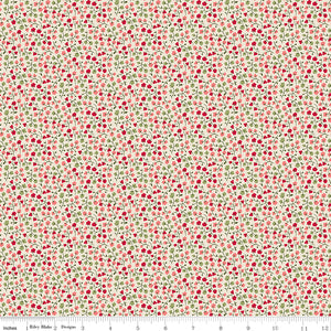 A seamless fabric pattern featuring a dense, small-scale print of red berries and green leaves on a warm cream background. A ruler along the bottom for scale.