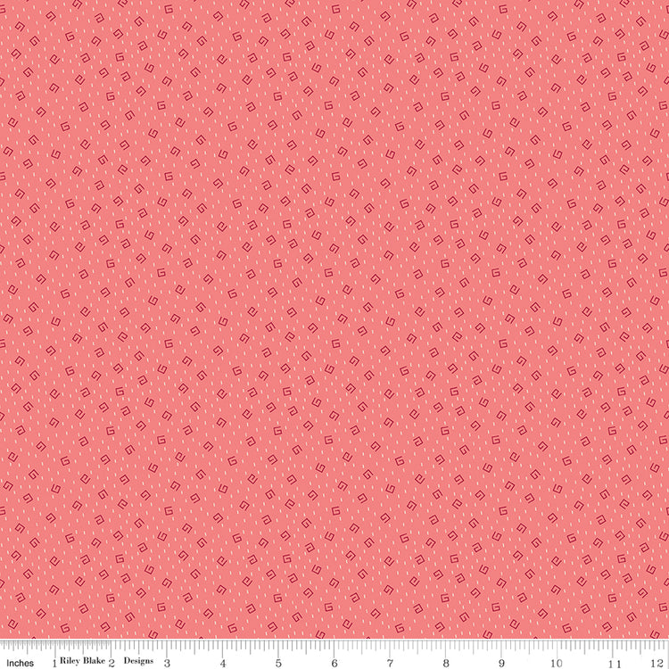 A repeating pattern of small dark red outlined diamonds on a coral pink background. Ruler along the bottom for scale.