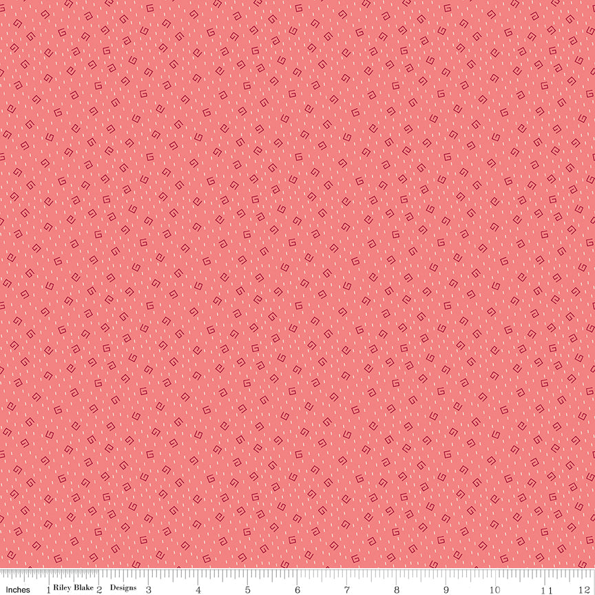 A repeating pattern of small dark red outlined diamonds on a coral pink background. Ruler along the bottom for scale.