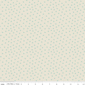 Blue fabric with white star pattern with ruler along the bottom for scale.