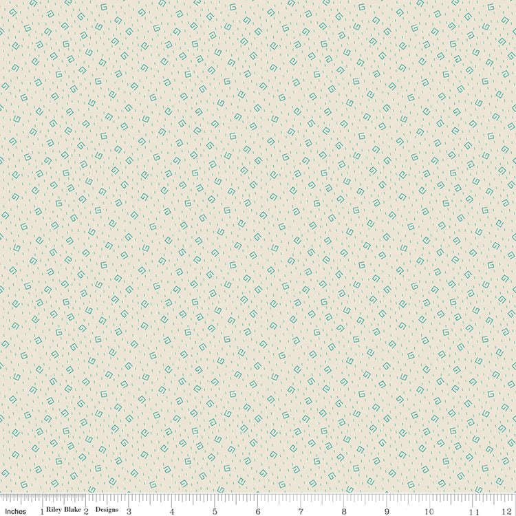Blue fabric with white star pattern with ruler along the bottom for scale.