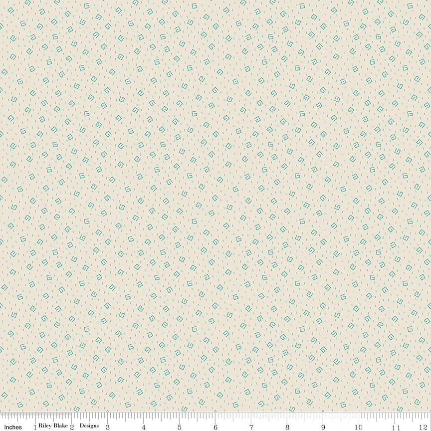 Blue fabric with white star pattern with ruler along the bottom for scale.