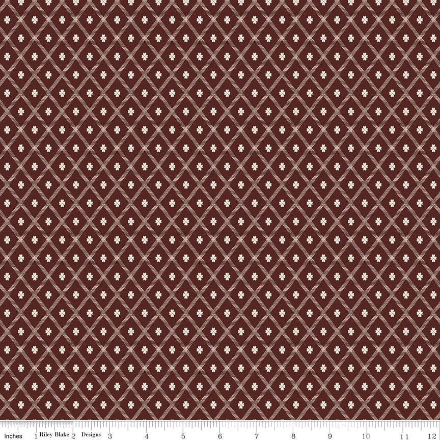 Northanger Abbey Thorpe Marsala fabric with cream diamond lattice on a rich reddish-brown background with ruler for scale.