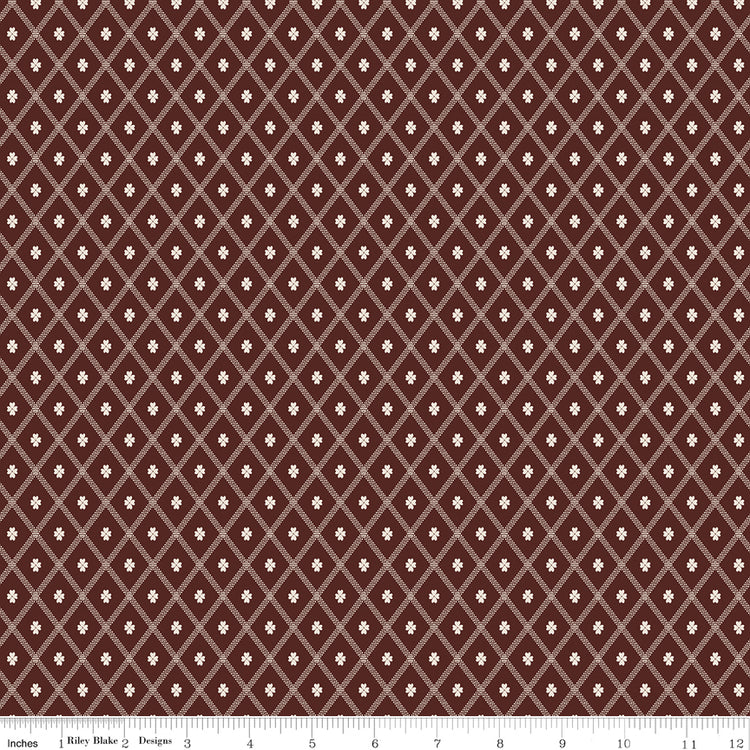 Northanger Abbey Thorpe Marsala fabric with cream diamond lattice on a rich reddish-brown background with ruler for scale.