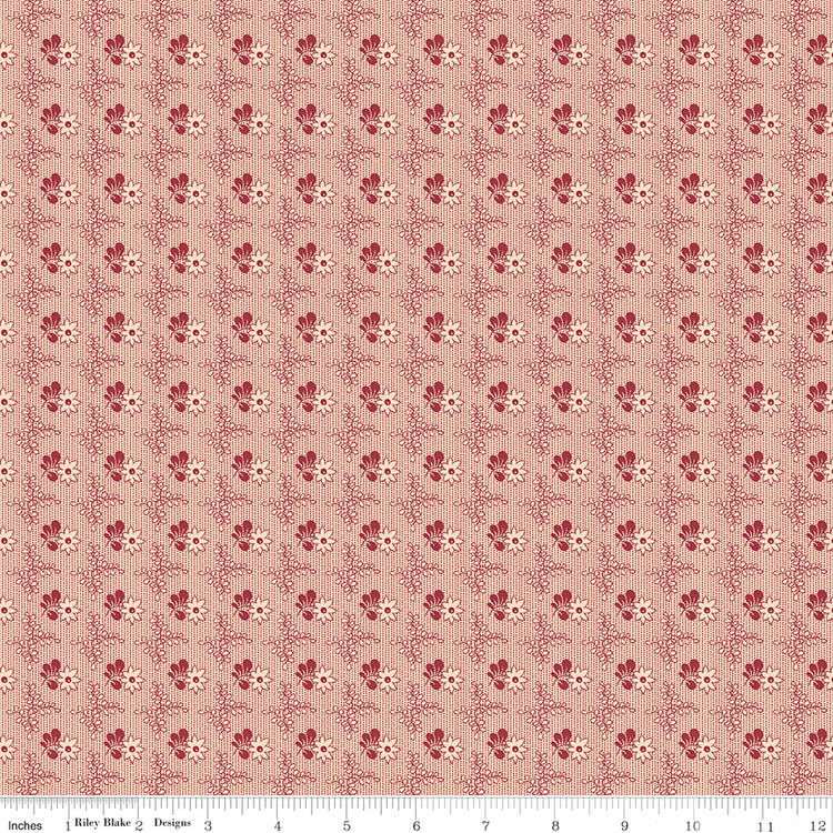 Northanger Abbey Richard fabric with small red floral motifs in a delicate repeat on pale peach with ruler for scale.