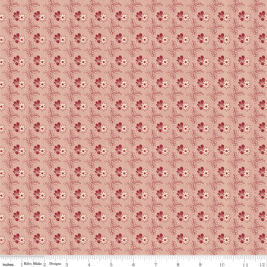 Northanger Abbey Richard fabric with small red floral motifs in a delicate repeat on pale peach with ruler for scale.