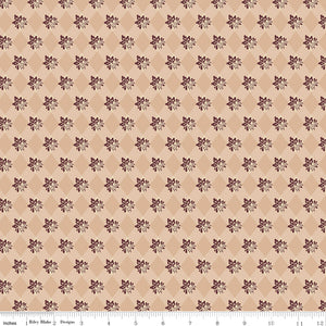 Northanger Abbey James fabric with plum floral sprigs over a tan and cream diamond pattern with ruler for scale.