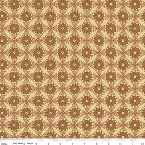 Northanger Abbey Fullerton fabric with brown flowers and radiating geometric lines on warm tan with ruler for scale.