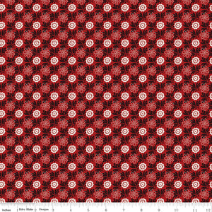 Northanger Abbey Captain fabric with cream and red flowers in a dense repeat on deep red with ruler for scale.