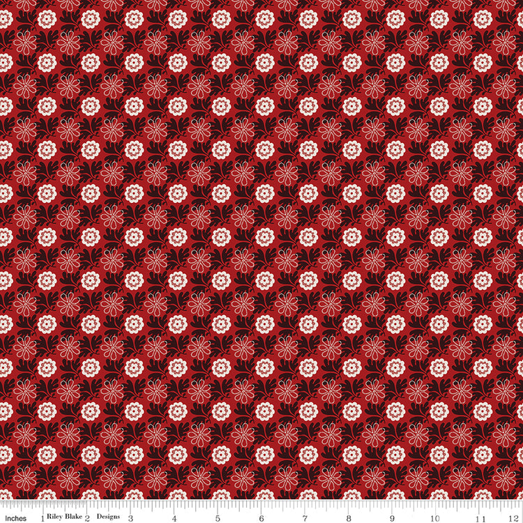 Northanger Abbey Captain fabric with cream and red flowers in a dense repeat on deep red with ruler for scale.